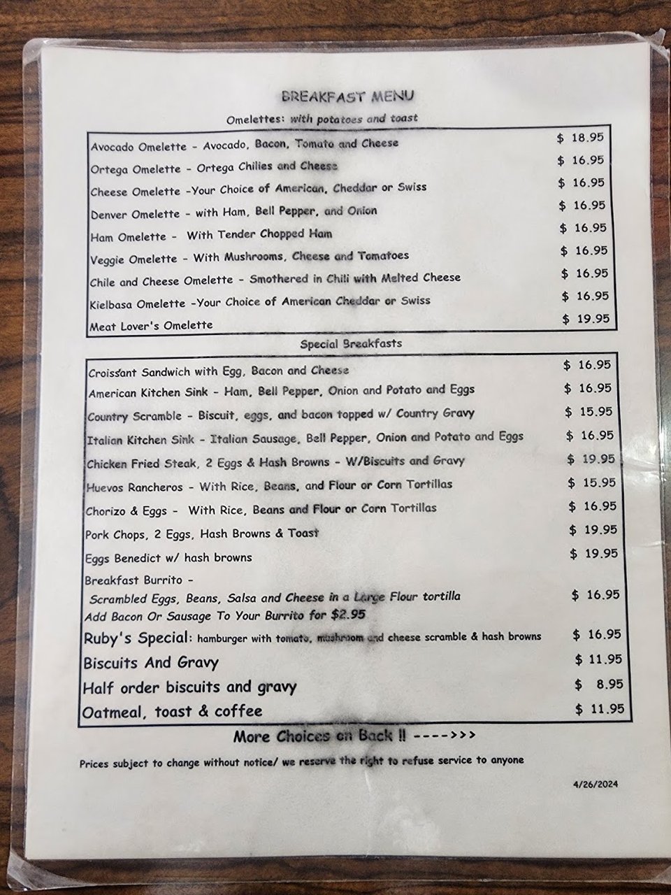 Breakfast menu beside a hot cup of coffee.